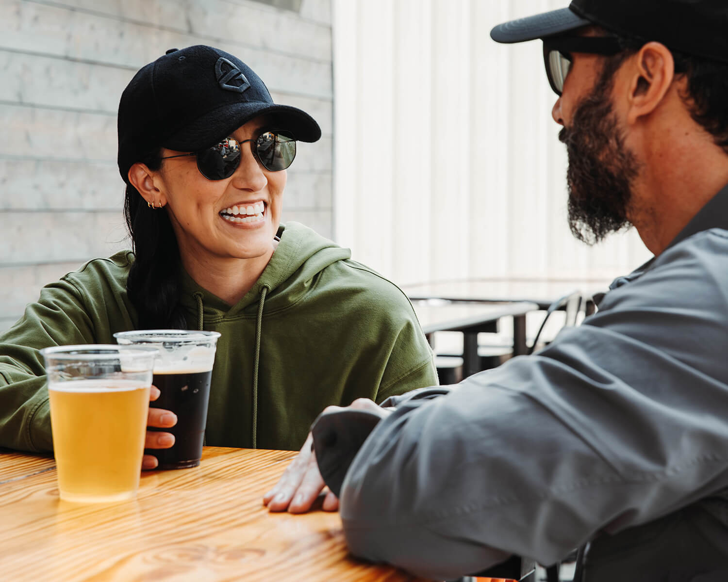 Man and woman out on a date at a brewery in Black Crest Athleisure 