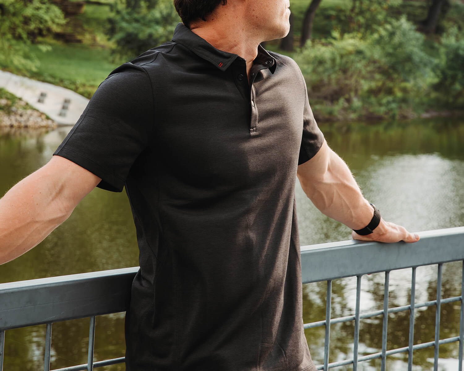 Sharp dressed man in Black Crest Urban Technical Polo in Black
